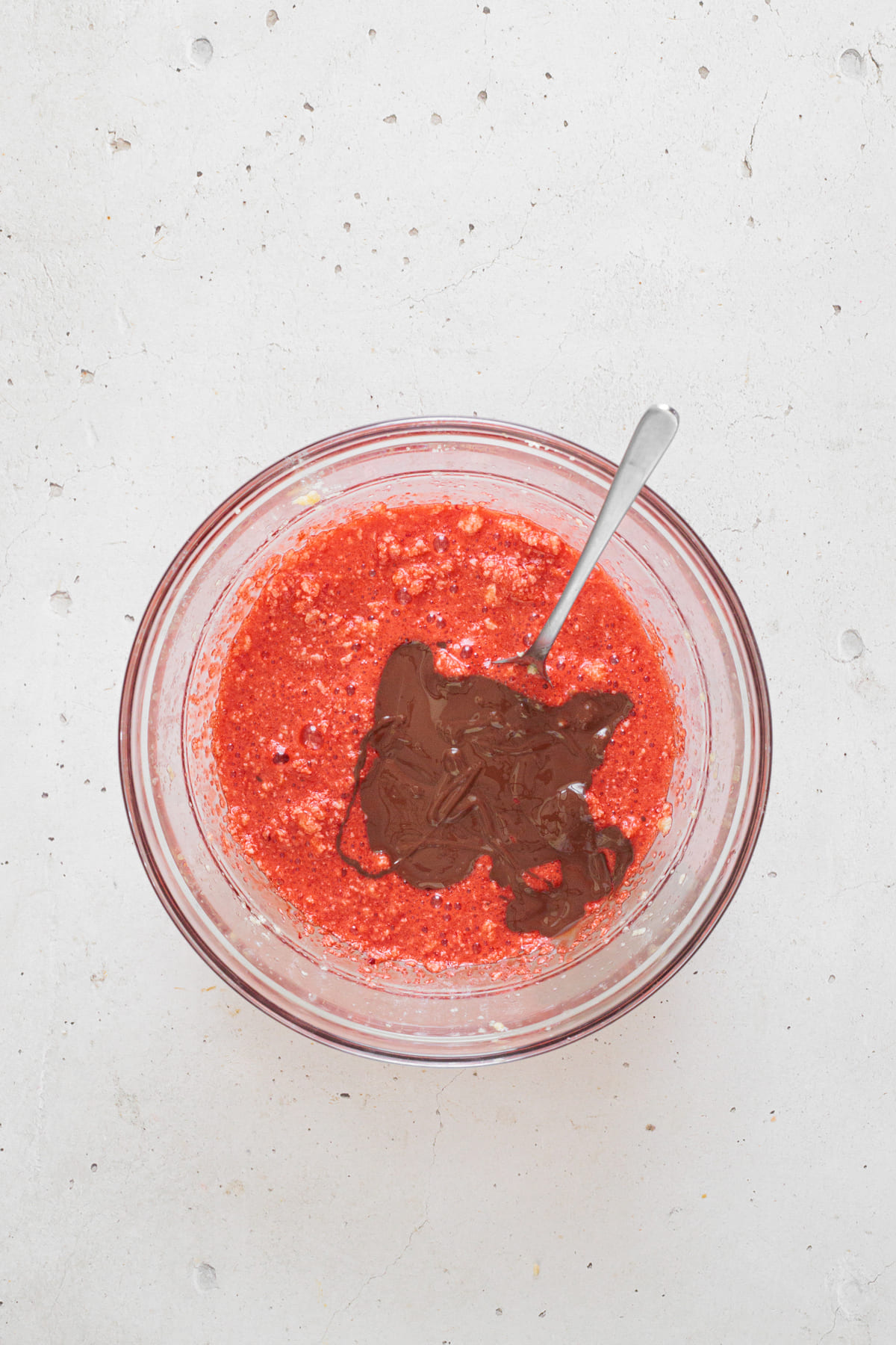 Melted dark chocolate added on top of the red cookie batter before mixing.