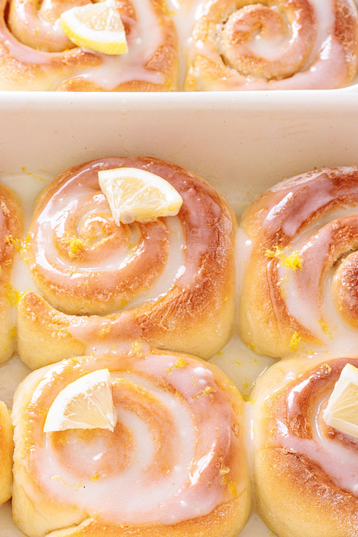 Freshly baked Lemon Sweet Rolls with glossy lemon icing.