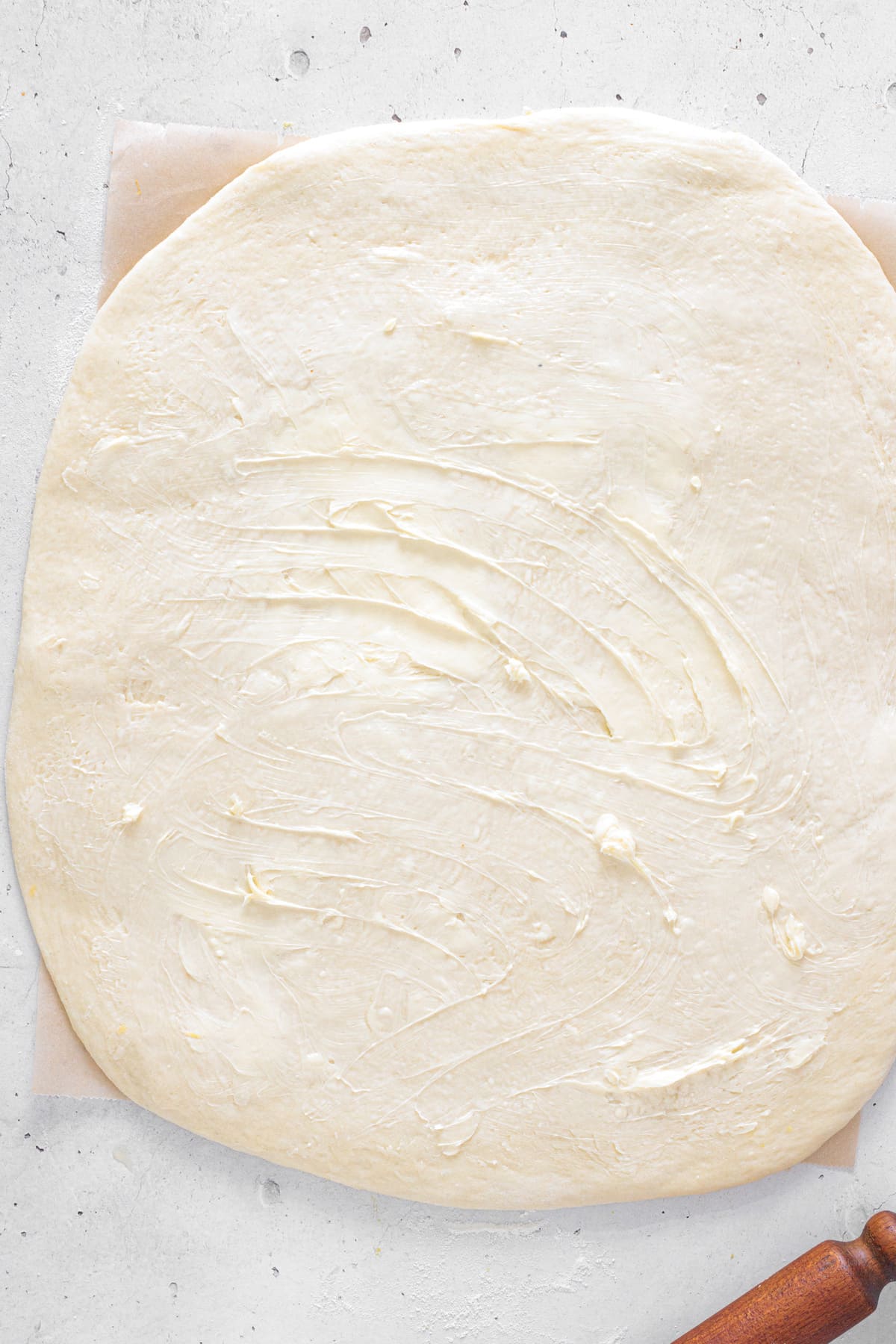 Roll out the dough and spread with softened butter.