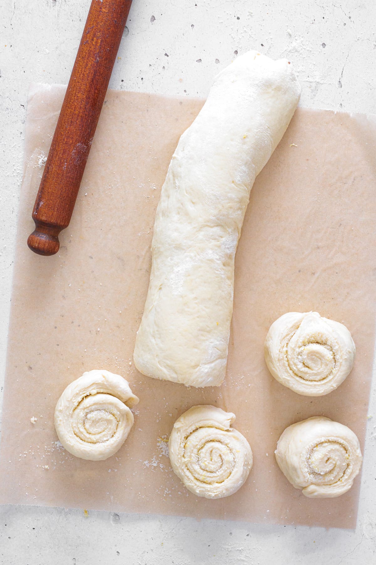 Roll the dough tightly and slice into even rolls.