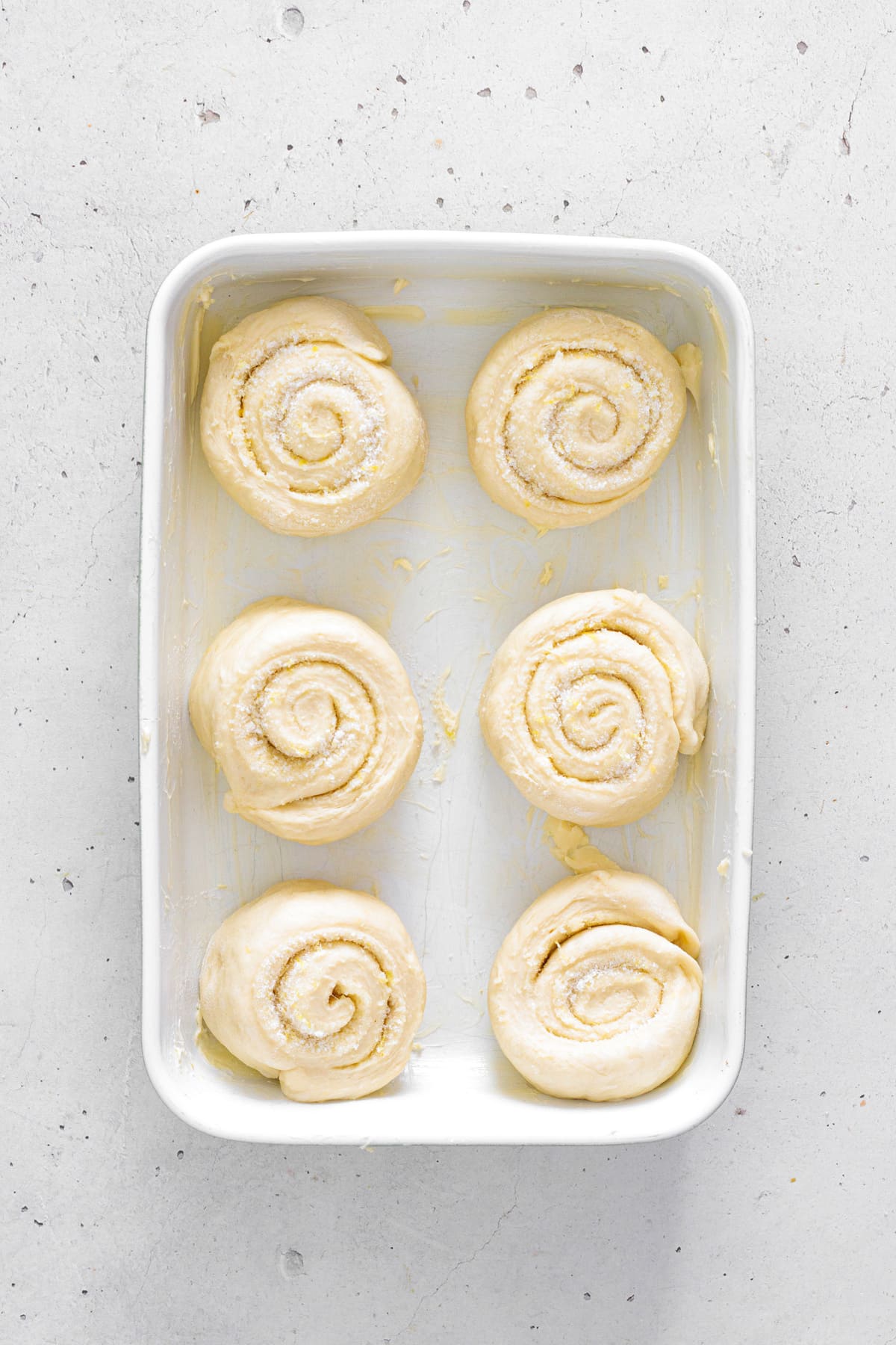 Arrange the rolls in a buttered baking dish to rise.