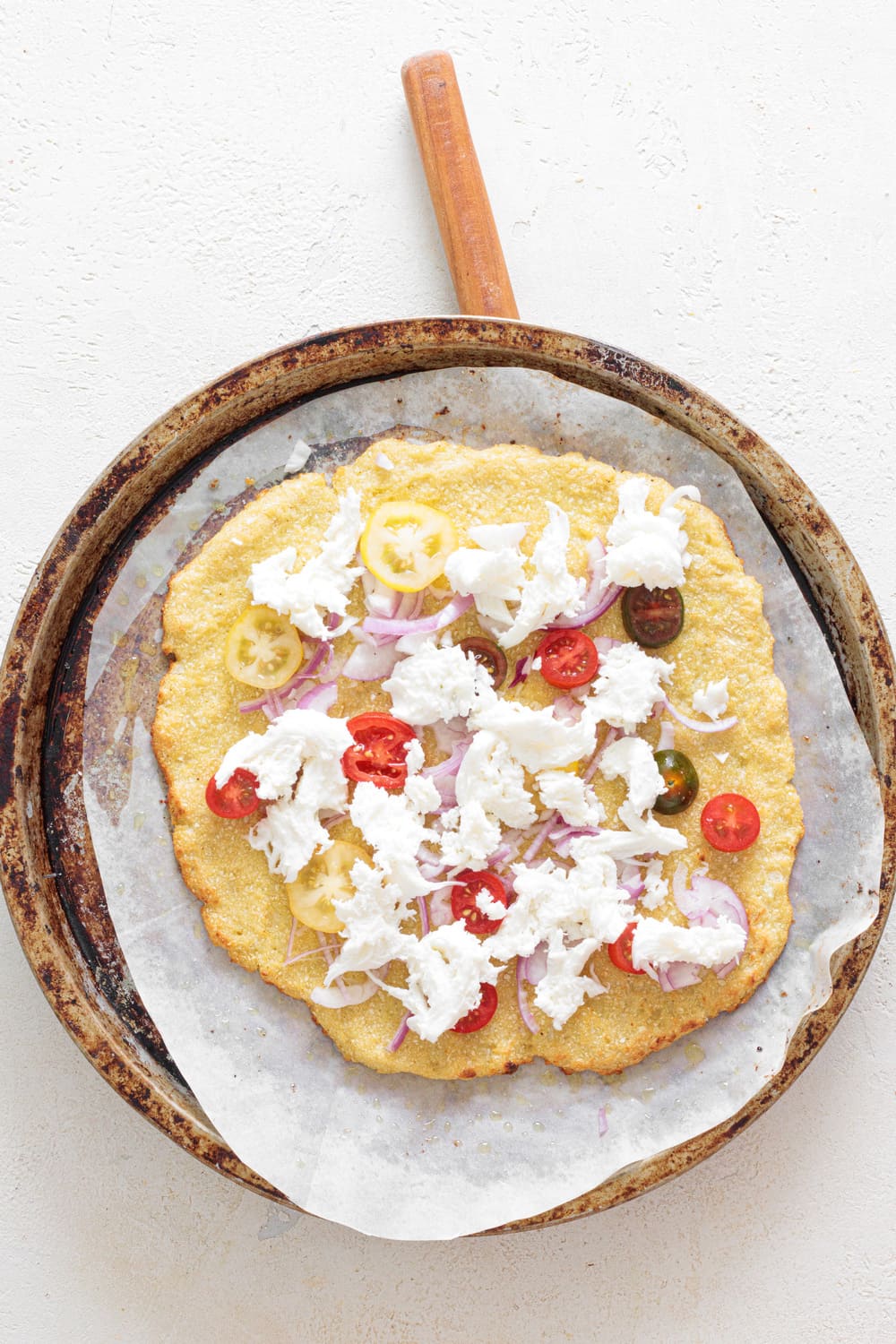 Add the toppings to your pre-baked pizza crust and return it to the oven for another 10 minutes.