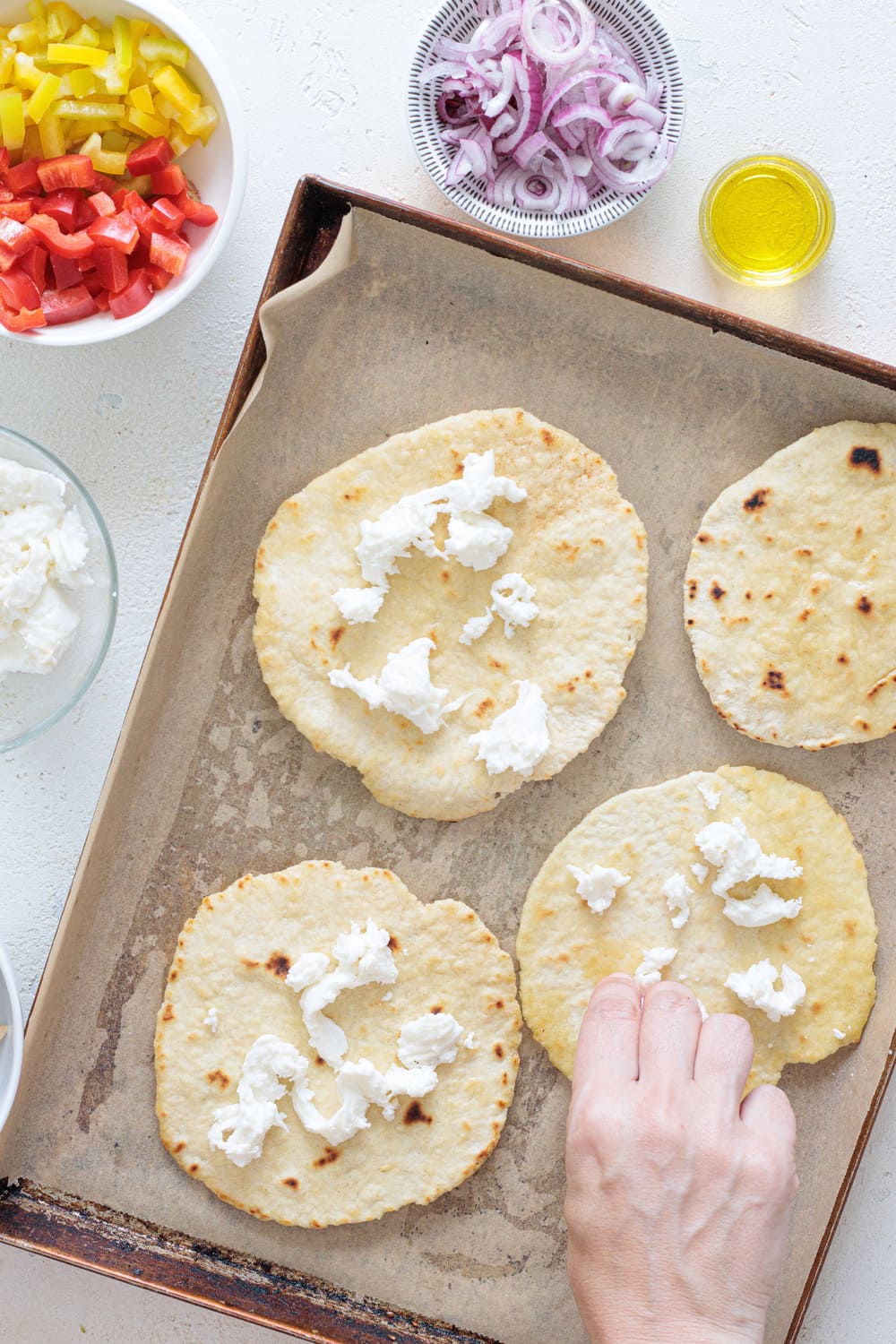 Place the flatbreads on a tray lined with parchment paper, then tear the mozzarella over them.
