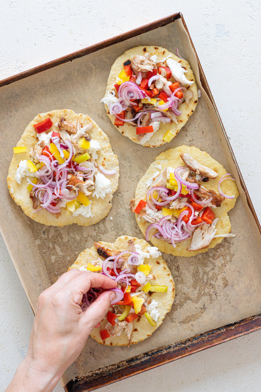 Add the peppers and a few slices of red onion and to the oven it goes.