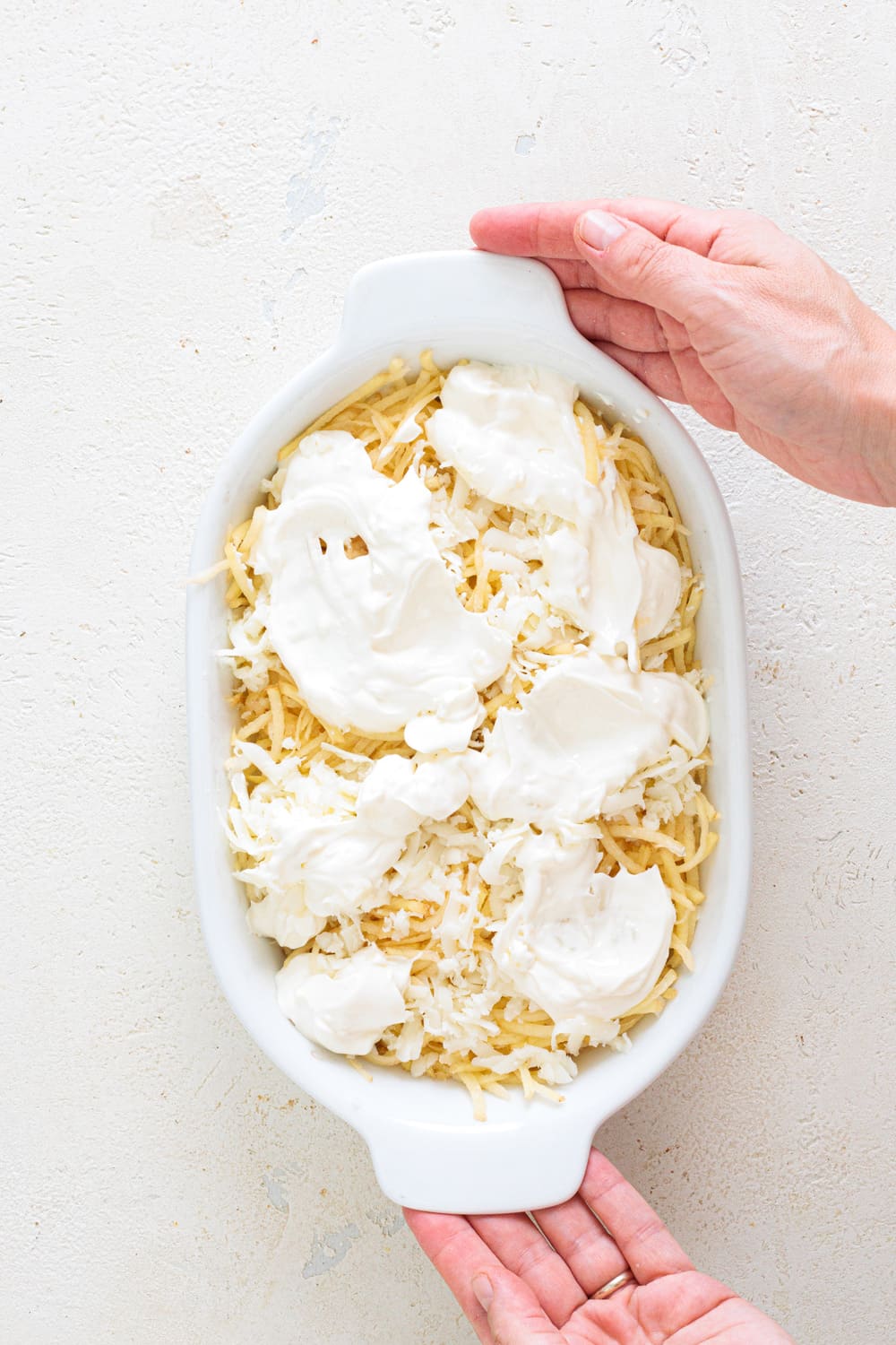 Pour the cream slowly over the top, trying to cover the surface evenly.
