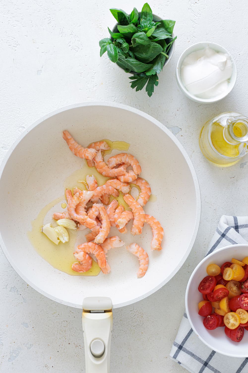 Heat a bit of olive oil in a pan with a crushed garlic clove, and add the shrimp.