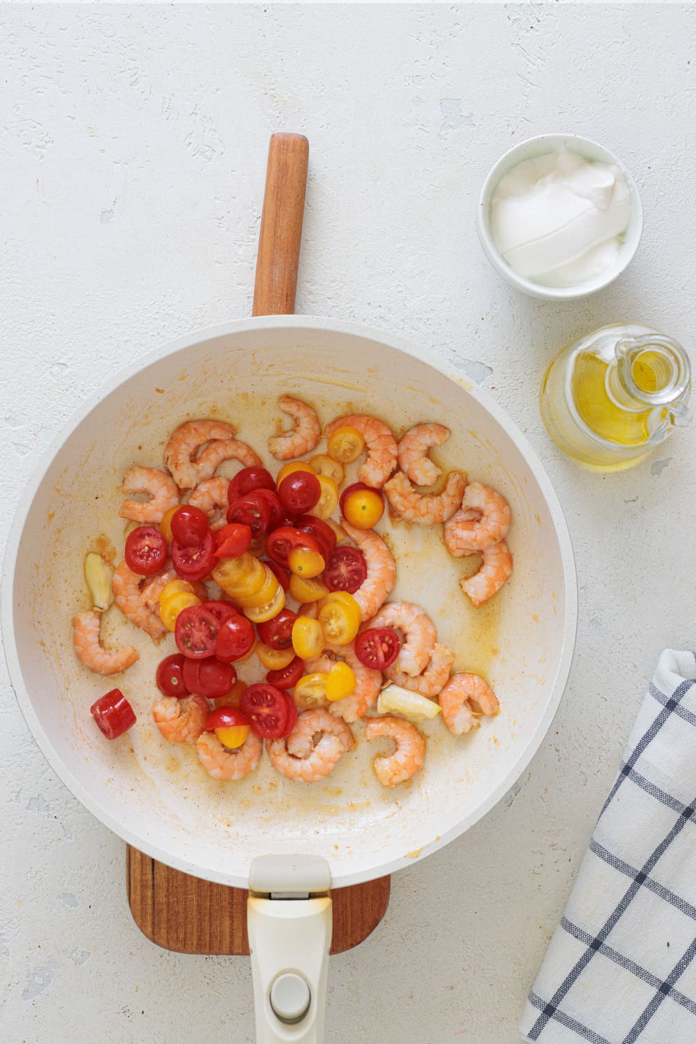 As the shrimp cook, add the tomatoes.