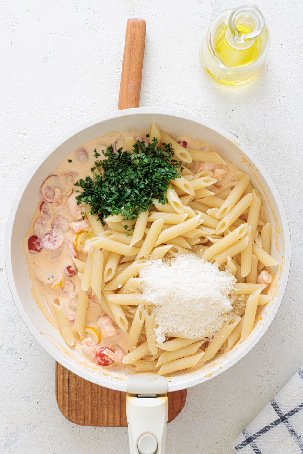 Add the pasta, parmesan, basil, and parsley.