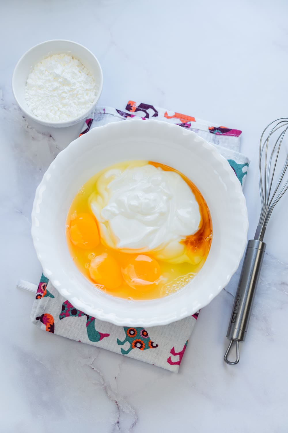 Mix eggs, sugar, vanilla extract, and yogurt in a bowl until smooth.