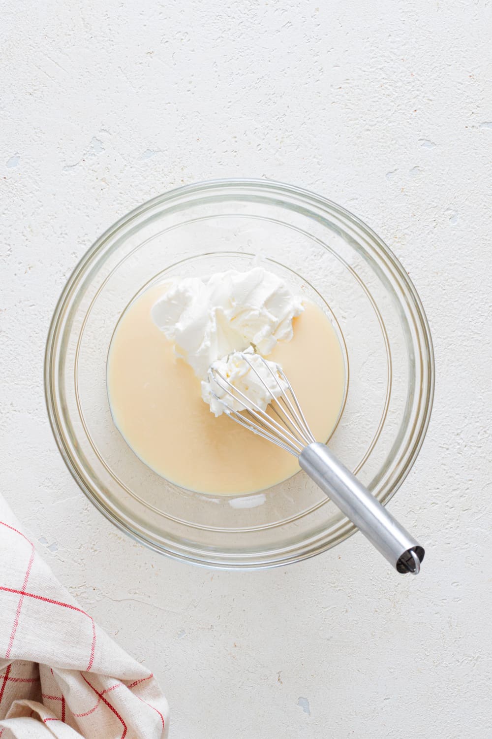 Whisk the cream cheese until smooth then add to the condensed milk.