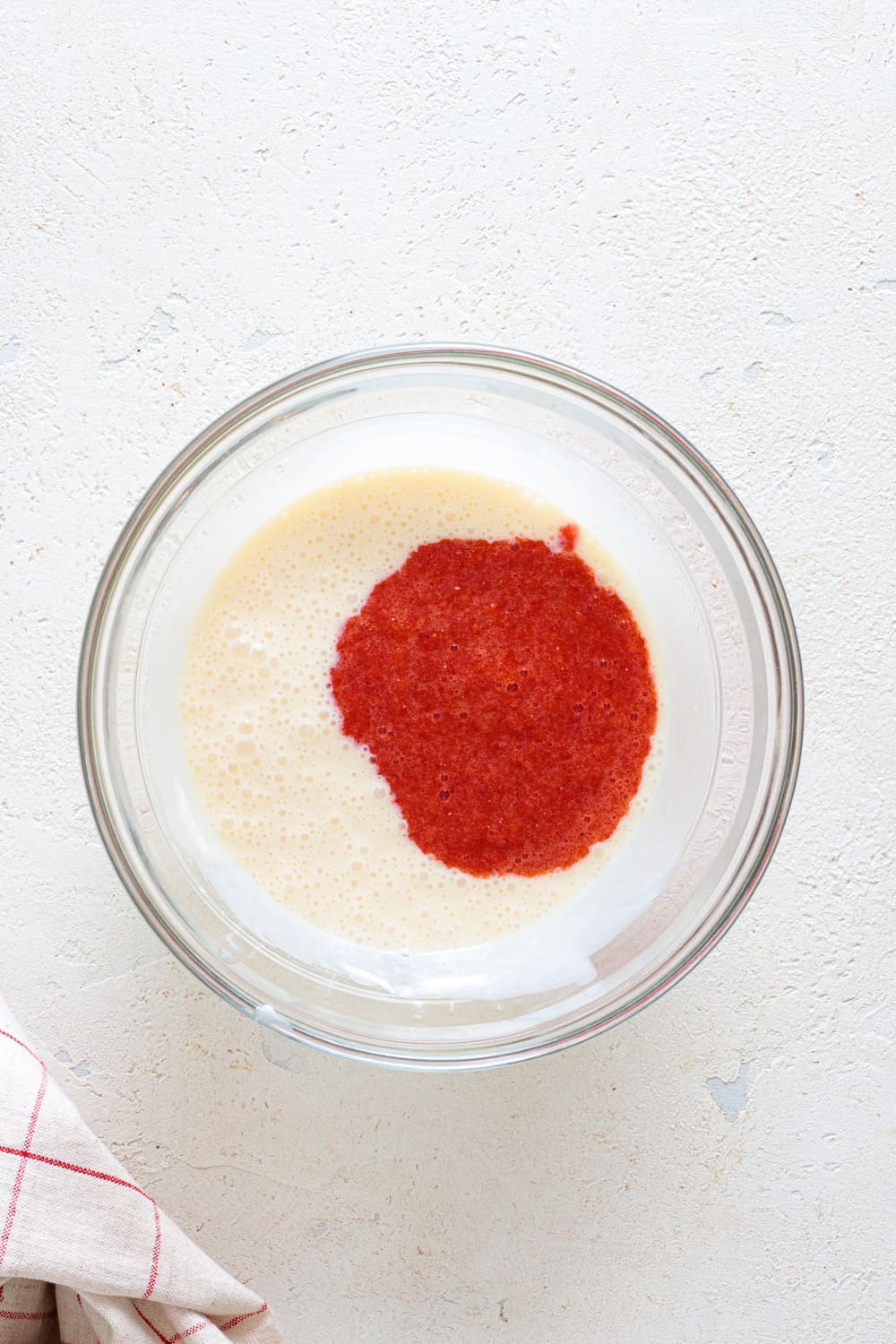 Add the strawberry purée to the condensed milk mixture.