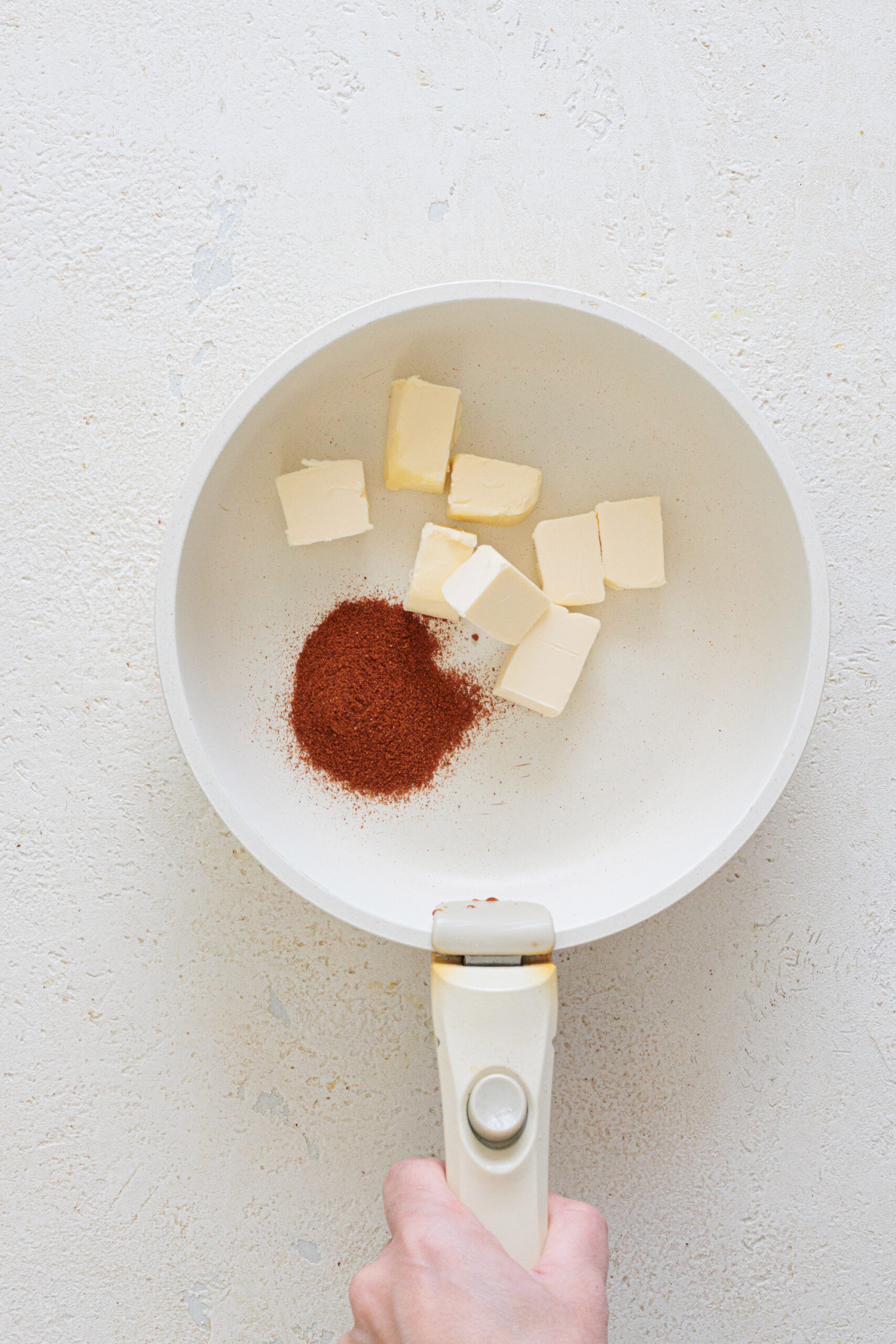 Add butter and paprika to a pan.