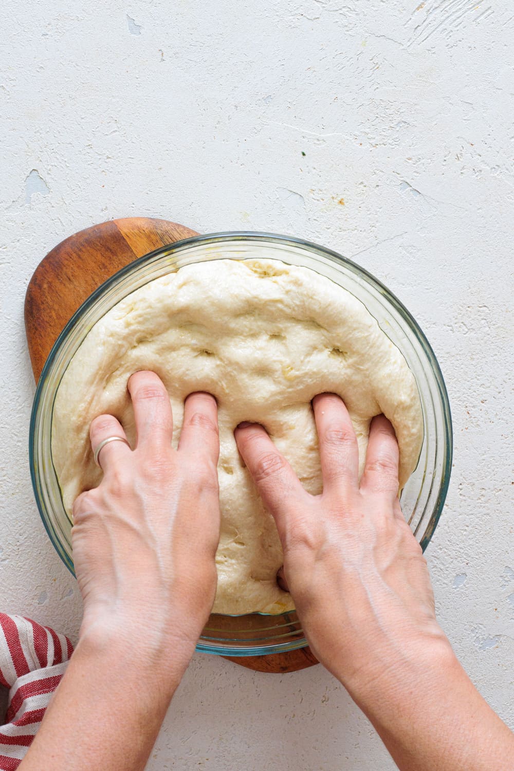 Using oiled hands, stretch the dough gently toward the edges.