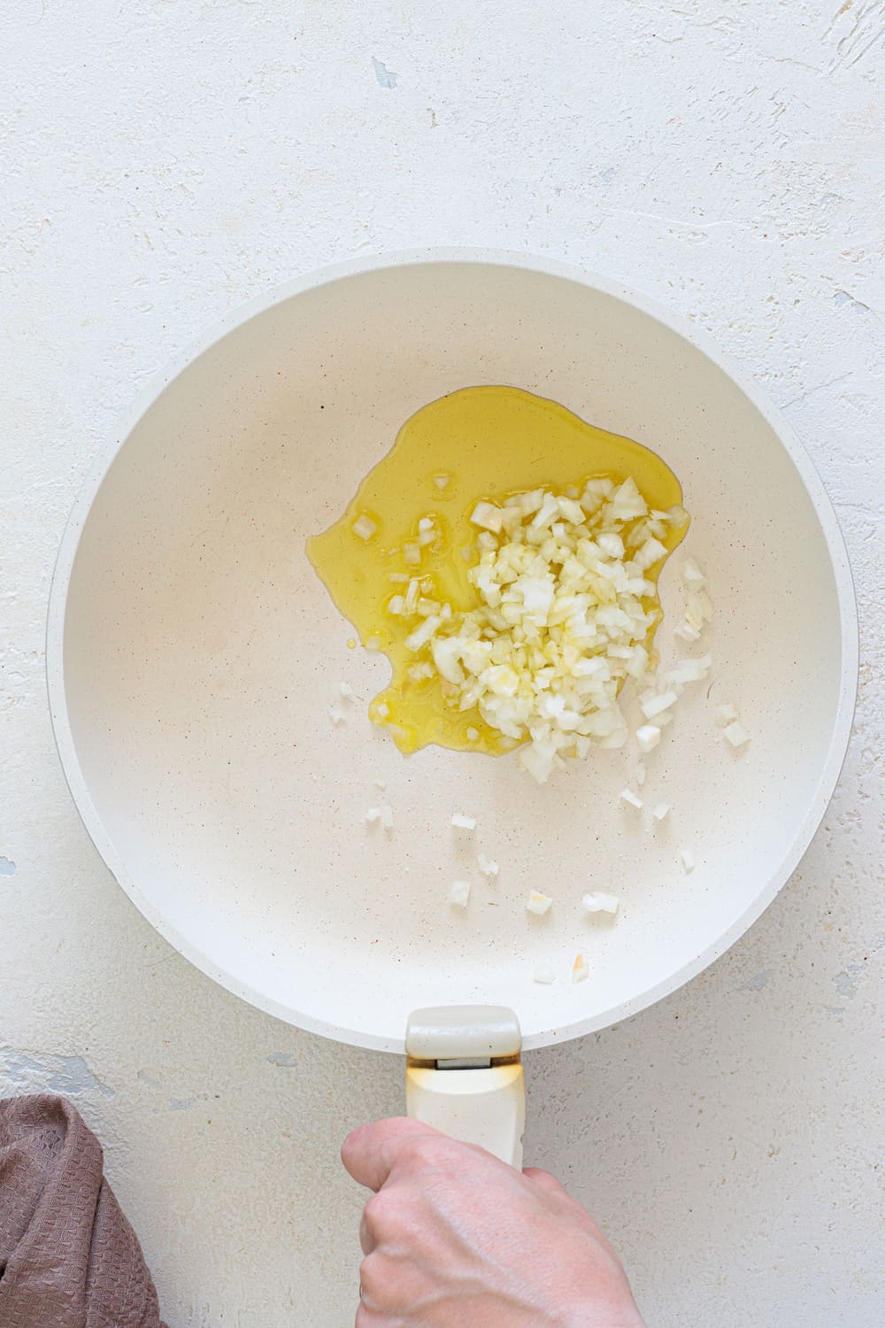 Add a little olive oil to the pan and cook the chopped onion with salt and pepper until soft and golden.