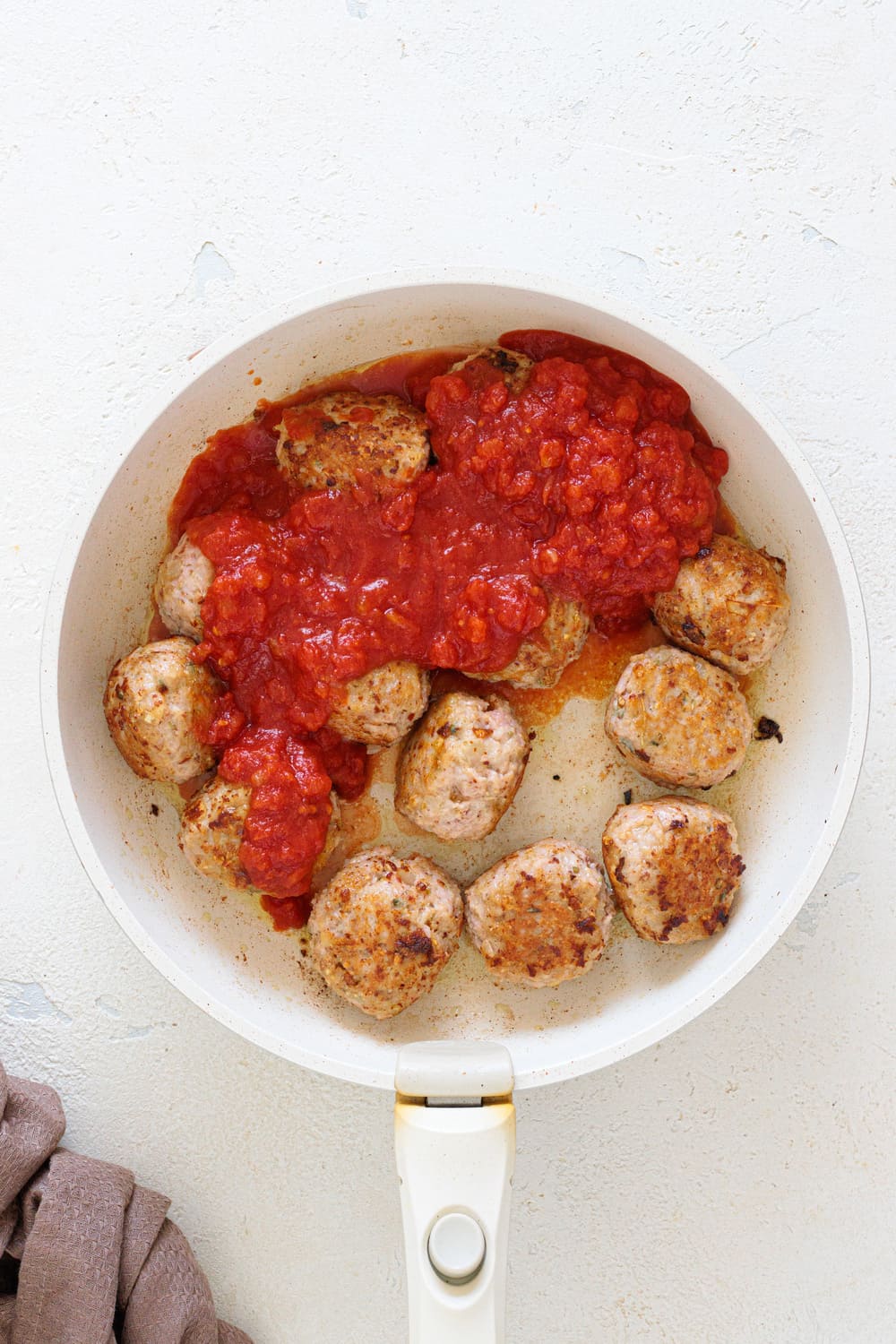 Get the meatballs browned before adding the tomato sauce, then let them simmer for a few minutes.