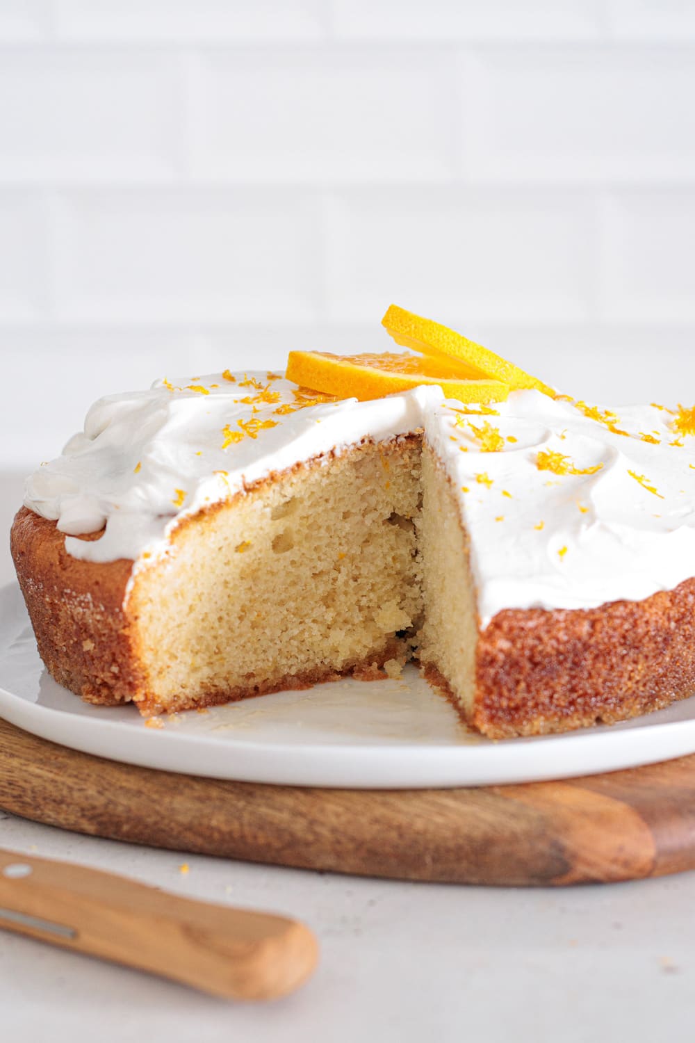Orange creamsicle cake slice with light whipped cream layer