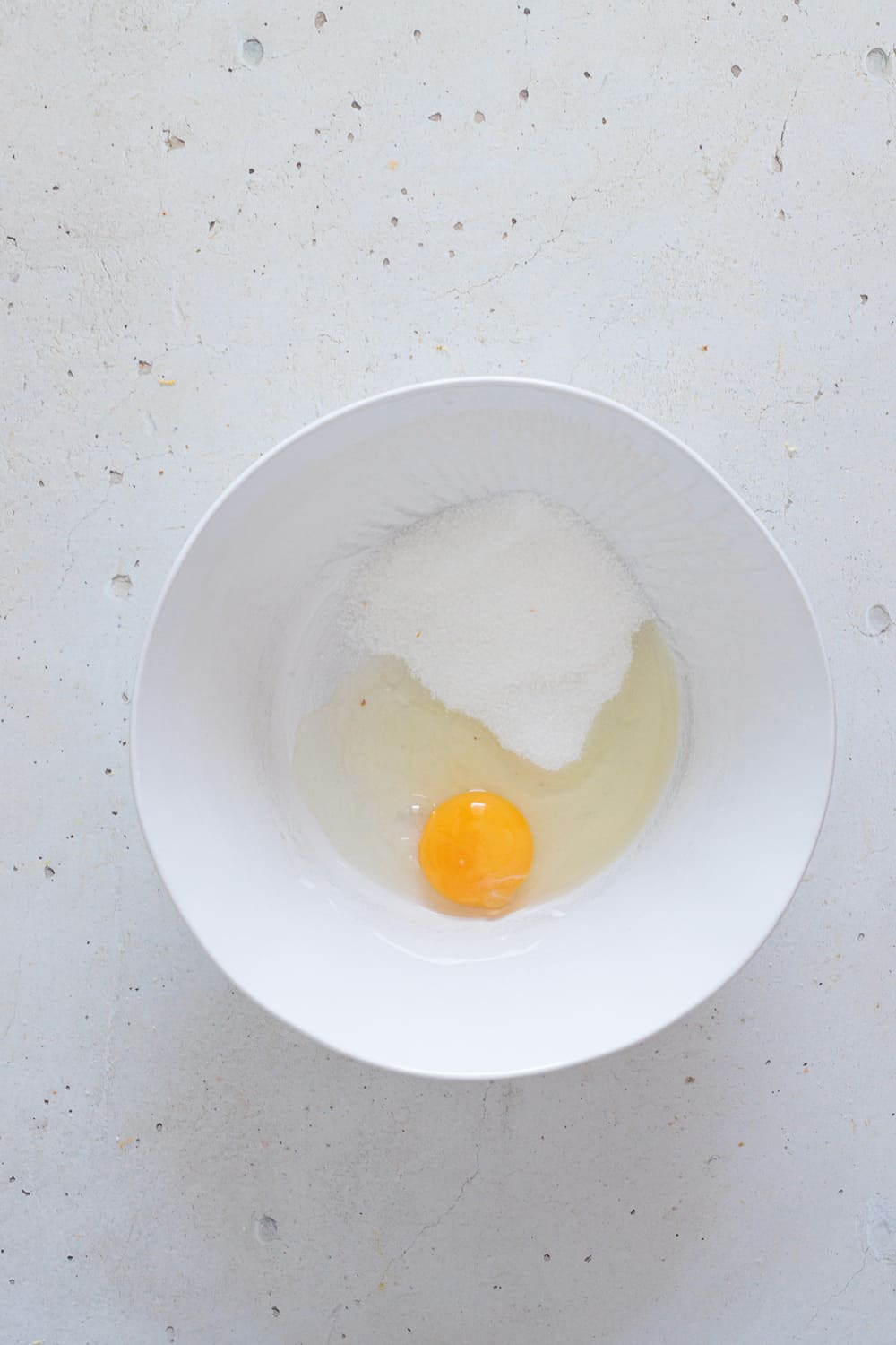 Add the egg and sugar to a bowl and whisk.