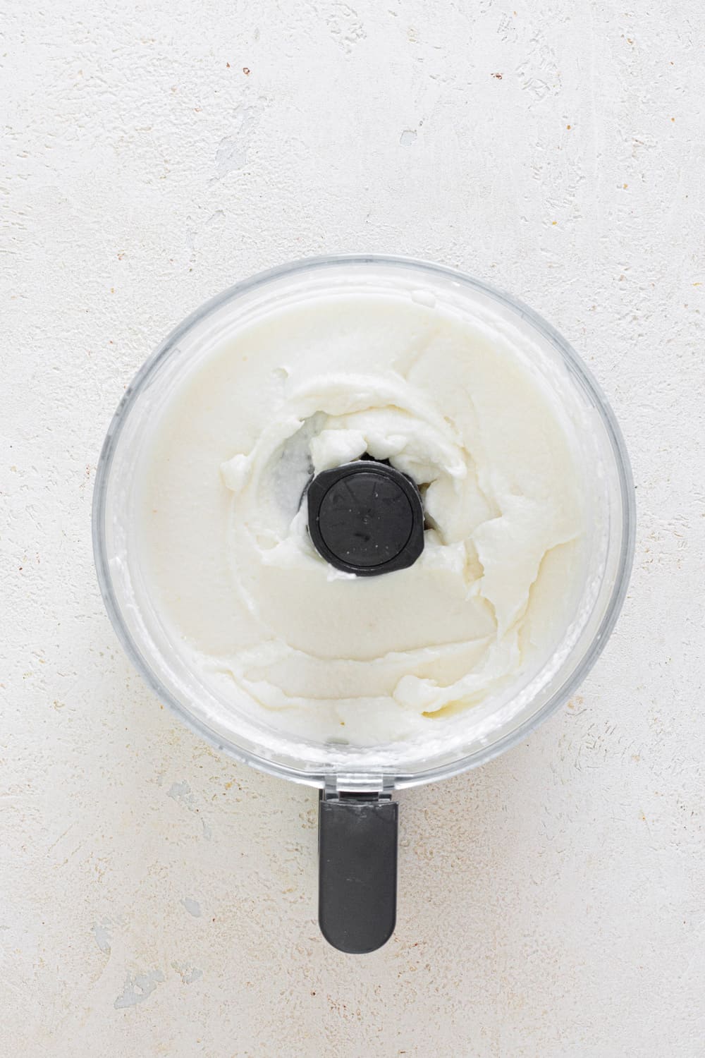 Add oil slowly and pulse. Then start alternating between oil and lemon juice until smooth.